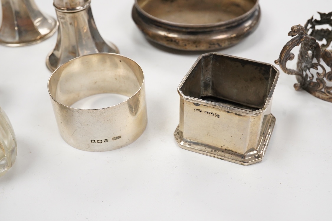 A collection of assorted silver to include five napkin rings including two pairs, a cased pair of glass butter dishes with silver butter knives, five golf related teaspoons, a cased set of six sterling cocktail sticks wi